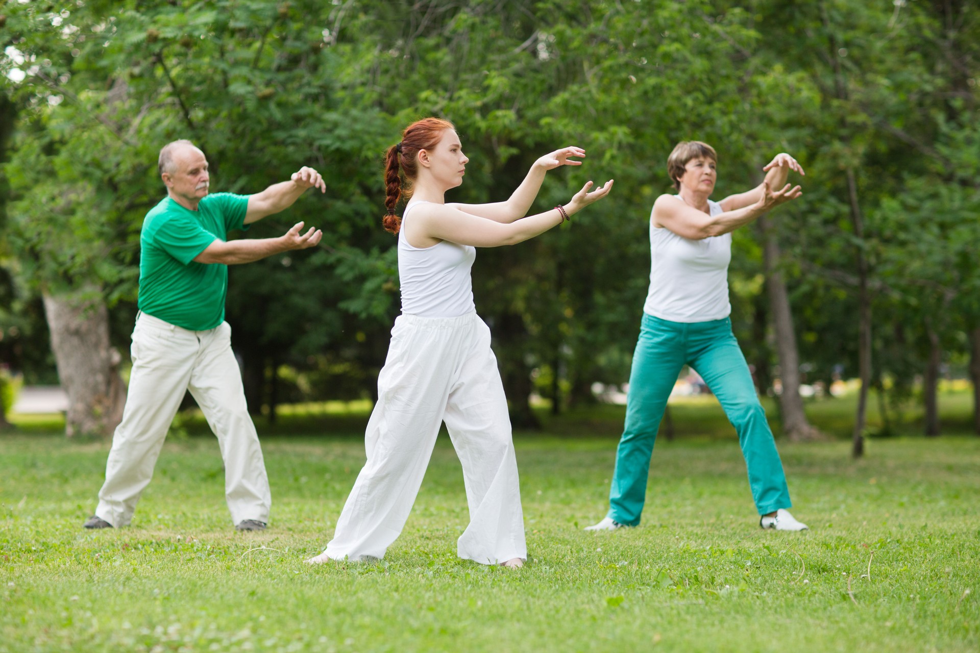 group of people practice Tai Chi Chuan in a park.  Chinese management skill Qi's energy.