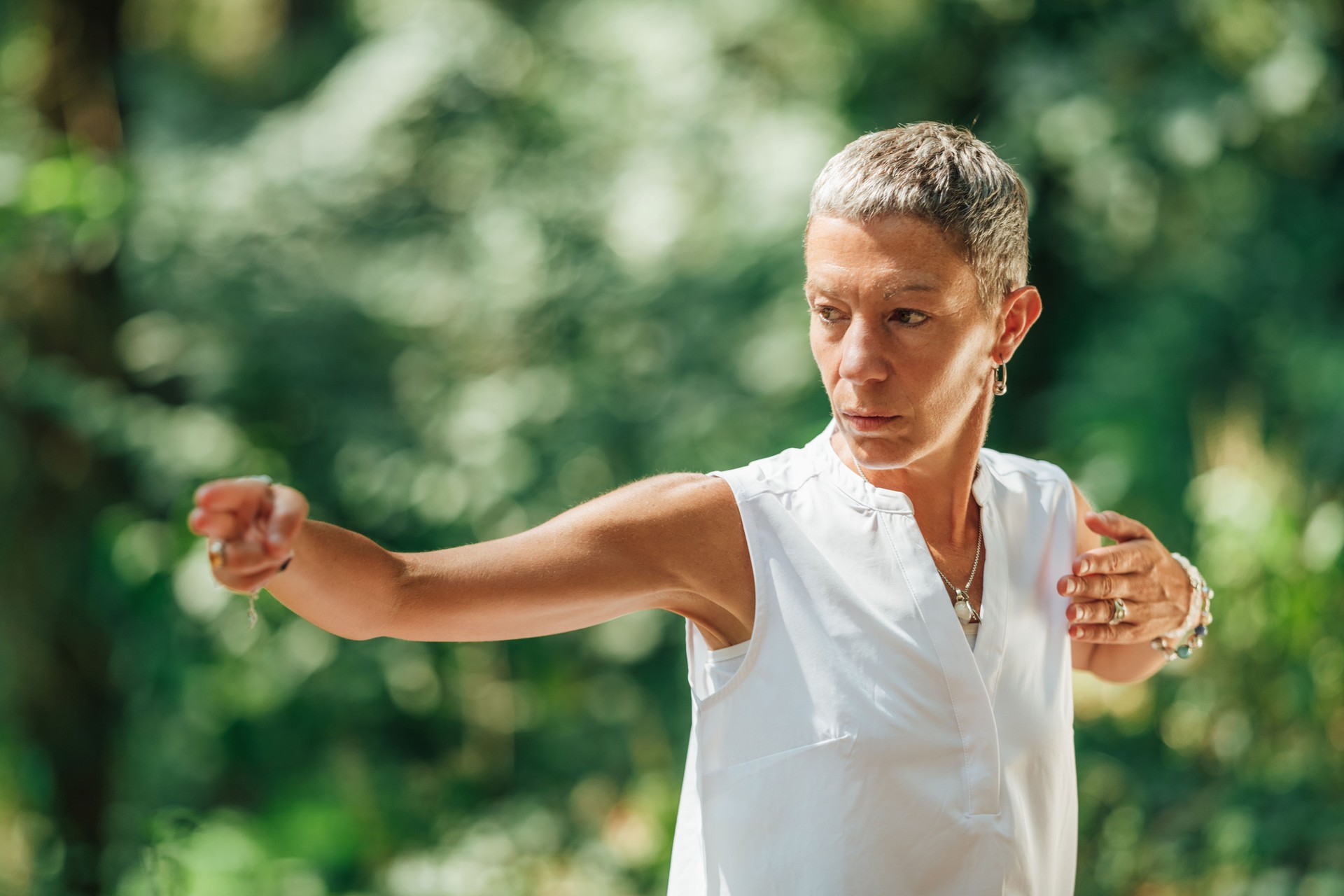 Qi Gong Female Expert Doing Qigong Exercises Outdoor for Moving "Chi" or Energy in the Body