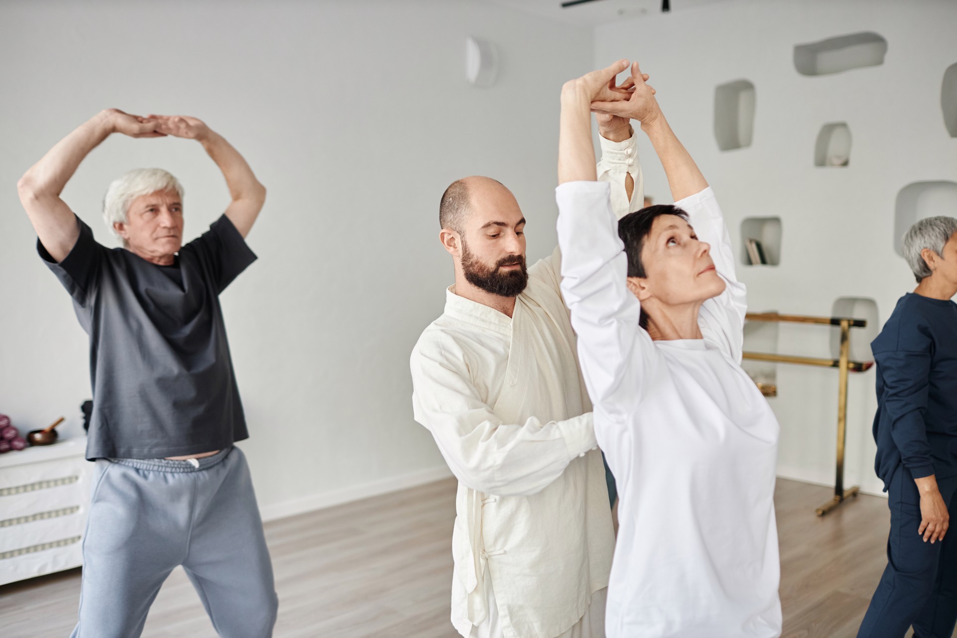 Elderly Yoga Students Performing Exercise with Trainer