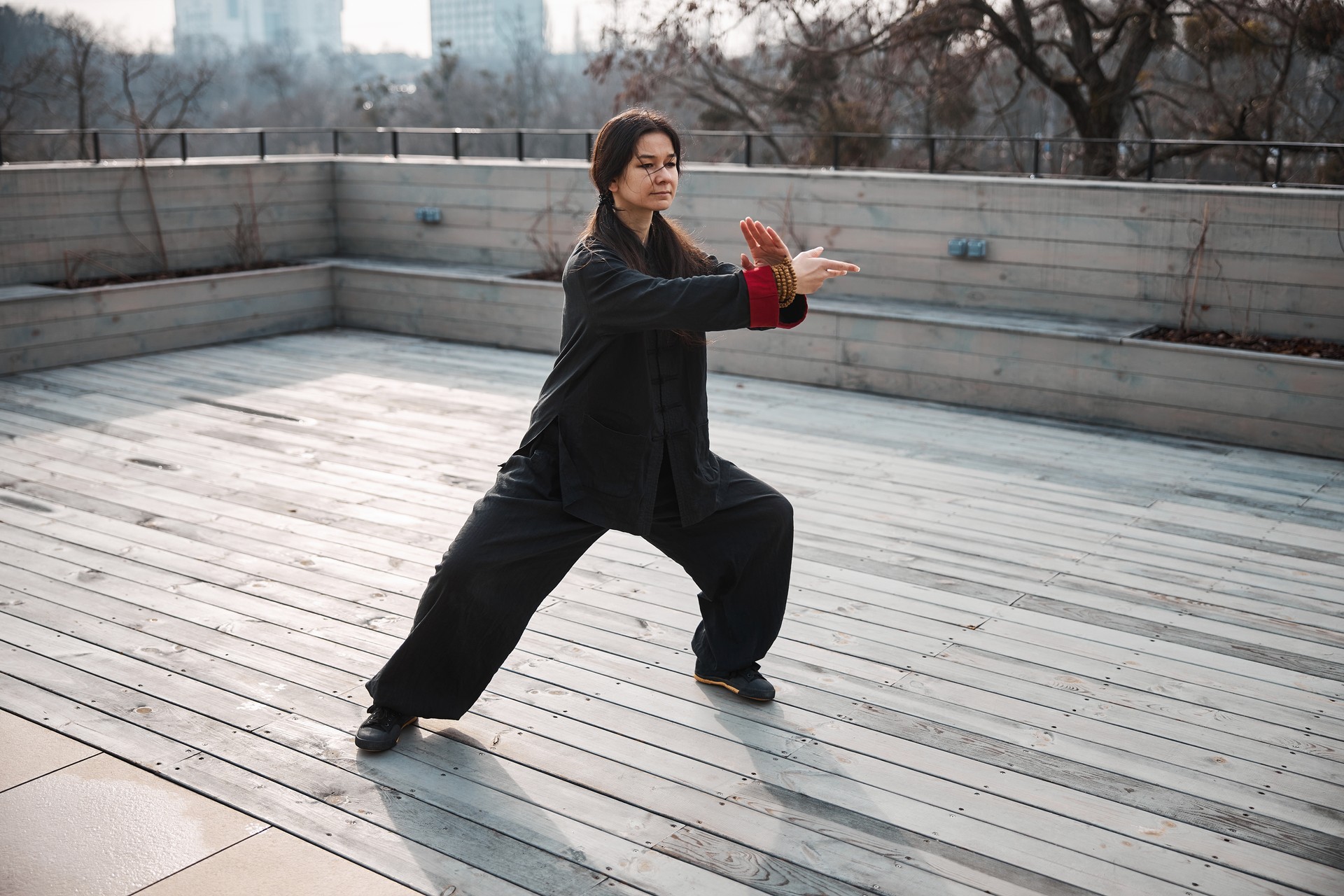 Cross hand stance of a woman doing tai chi